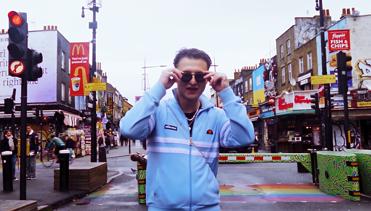Liam C on a London street with a red double-decker bus behind him